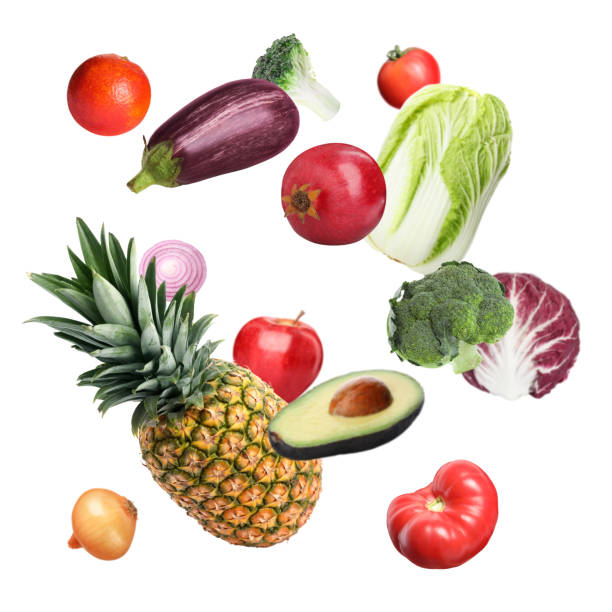 istock Many fresh vegetables and fruits falling on white background 1499088523
