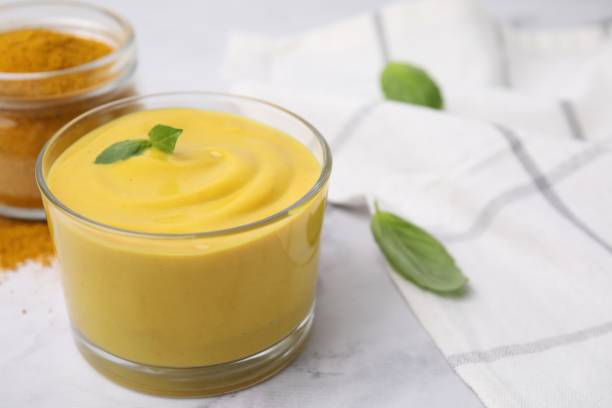 istock Tasty curry sauce, powder and basil leaves on white table, closeup. Space for text 1499088690