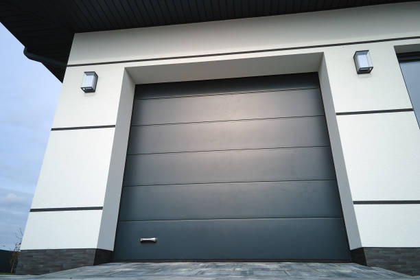 istock Automatic electric roll-up commercial garage gate or push-up door in modern private building ground floor 1499102674