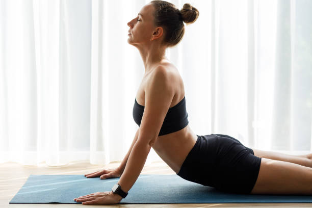 istock Young yoga woman doing back-bend stretching on the mat 1499107852
