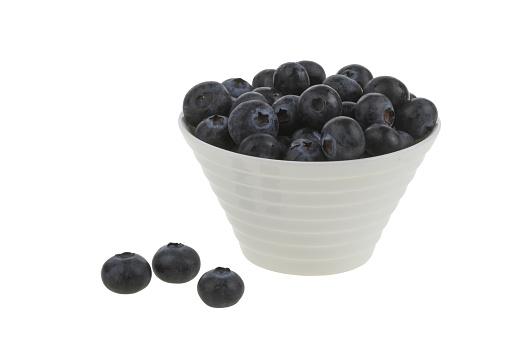 Frozen blueberries and bunches of red berries in metal bowls. Flat lay. White background.