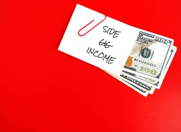 istock On red copy space background, dollars cash money with text note SIDE GIG INCOME, concept of financial planning - make more money or extra earning from part time side hustle , second job or side gig to increase income 1499111864