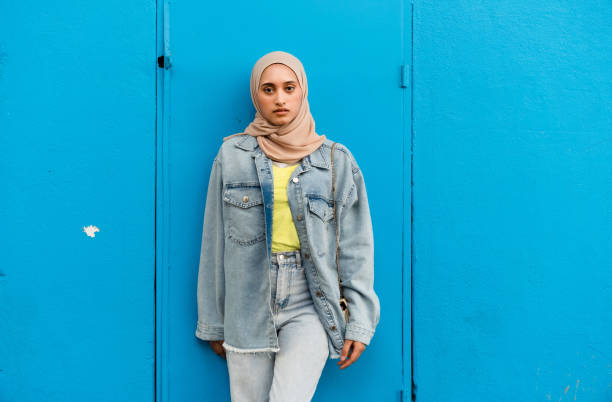istock Muslim Asian woman isolated against blue backdrop. 1499113830