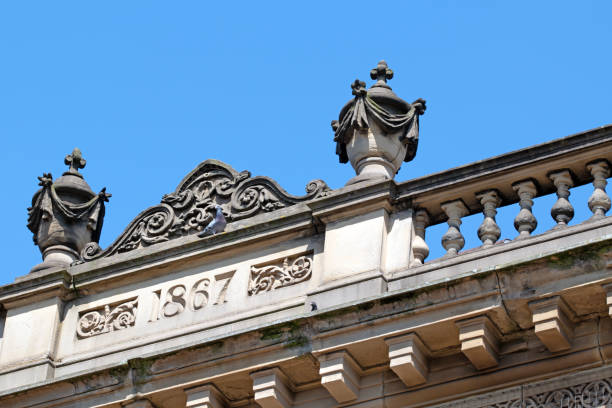 Sandstone carved urns on building roof