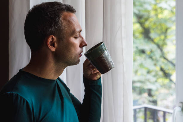 istock Young adult man drinks coffee with closed eyes 1499115740
