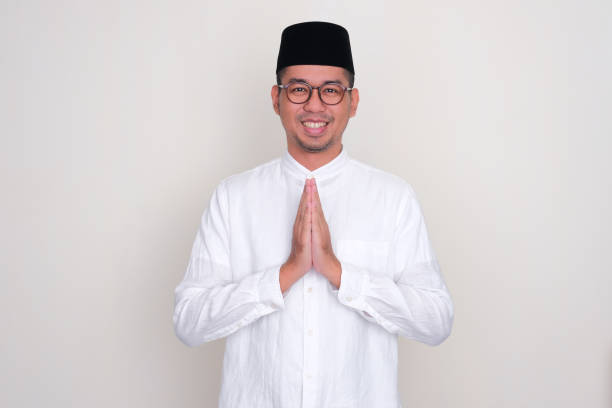istock Moslem Asian man smiling when doing warm greeting 1499118207
