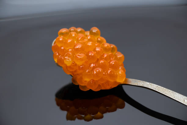 istock spoon with red salmon caviar on a black plate close up 1499120611