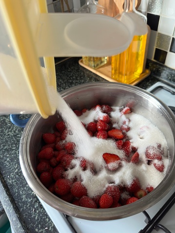 We pour sugar on strawberries to make jam