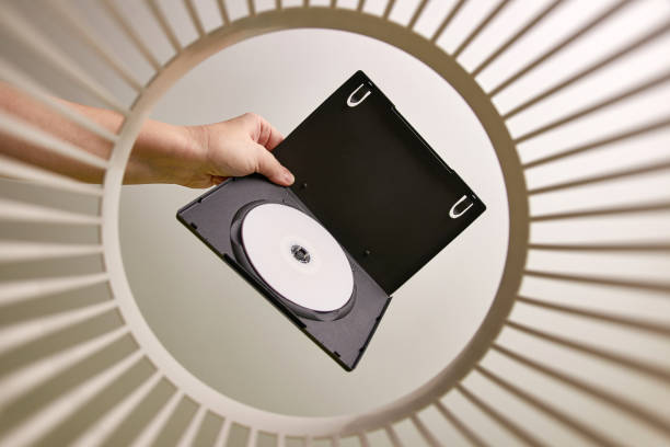 istock The DVD disc is thrown into the trash for disposal and recycling. View from below. The concept of disposal and processing of waste. 1499128171