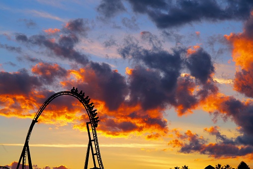 The scaring loops of a rollercoaster at sunset.