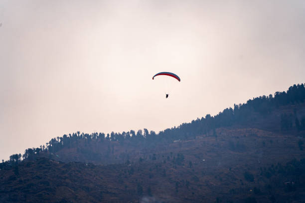 istock para sailing against sunset sky and mountains with copy space and bright colors showing freedom in hill station 1499131057