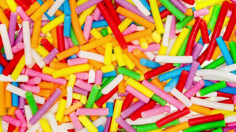 Sprinkling, multicolored sticks round close-up, rotating, turning, macro, top view