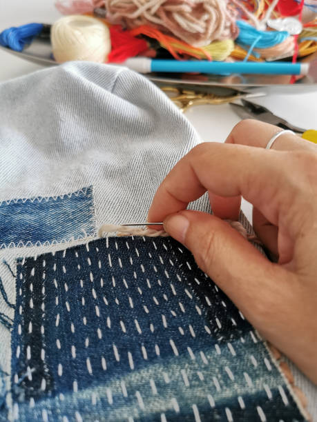 istock Handcraft work at home, hand sewing various types of denim fabrics patchwork 1499135198