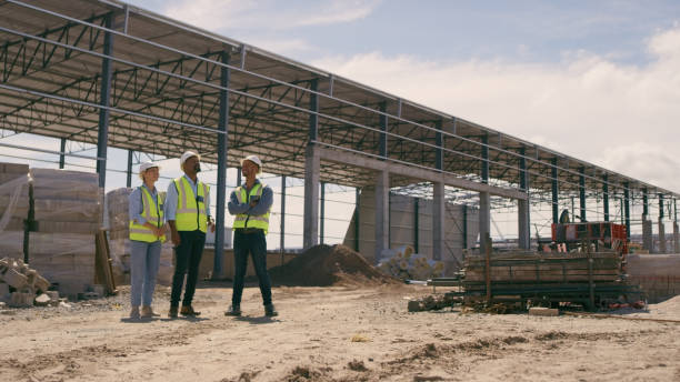 istock Architecture, team project and construction site outdoor for building, engineer and vision talk. Contractor people planning together  for collaboration, engineering and infrastructure development 1499135624