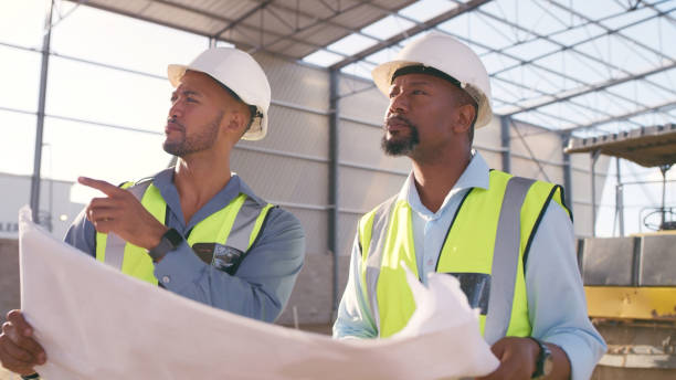 istock Architecture people, blueprint and outdoor planning, teamwork or collaboration at construction site. Engineering project, floor plan and contractor or partner in building development 1499135633
