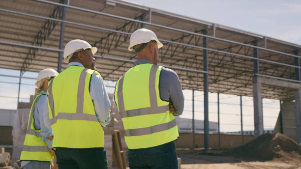 istock People, architect and walking in construction site for planning, collaboration or teamwork. Engineer, builder or contractors discussing team project plan for industrial building architecture 1499135704