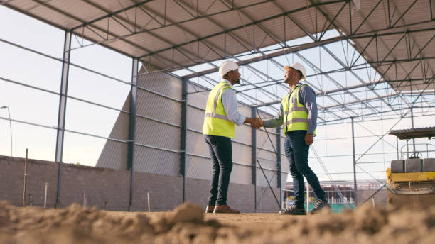 istock People, architect and handshake for deal in construction, partnership or teamwork success on site. Engineer, builder or contractor shaking hands in collaboration for project or architecture 1499135720