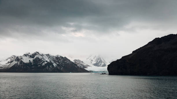 Coronation Island Coast Panorama. Moody twilight skyscape over the Laws Glacier and Mountain Range of the Coronation Island Coast, South Orkney Islands. Coronation Island, Laws Glacier, South Orkney Islands,  South-West of South Georgia Islands, Sub Antarctica Islands, Antarctica - Administration belongs to the Antarctic Treaty System.
