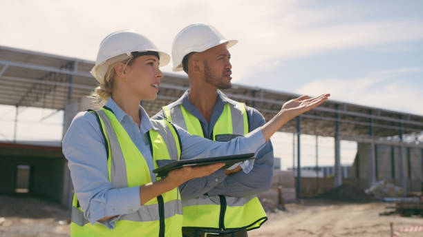 istock Talking, construction worker and tablet outdoor for planning building, architecture and vision. Engineer team or people on app for collaboration and innovation for engineering development 1499135862