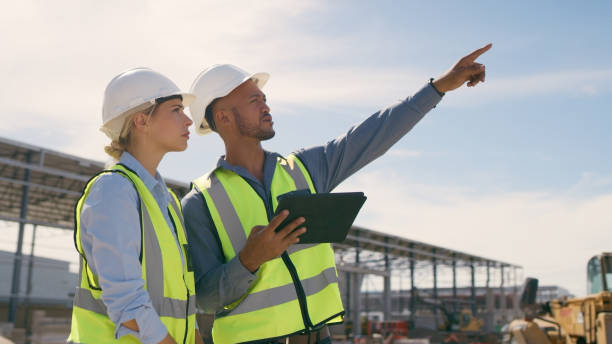 istock Talking, construction worker and tablet outdoor for planning building, architecture and vision. Engineer team or people on app for collaboration and innovation for engineering development 1499135865