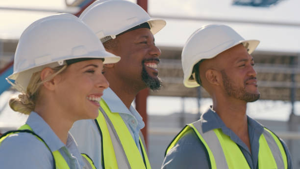 istock Civil engineering, diversity and group of people at construction with smile, leadership and cooperation. Happiness, men and woman in or contractor team working together on building project 1499135867