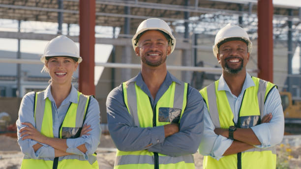 istock Construction team, collaboration and portrait outdoor for building and architecture. Happy engineer men and woman with arms crossed for teamwork, project and engineering development 1499135870
