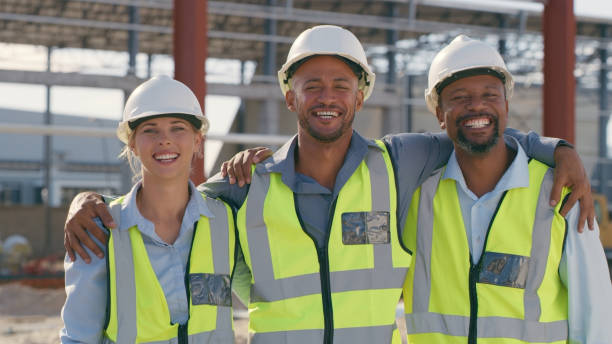 istock Construction team, collaboration and portrait outdoor for building and architecture. Happy engineer men and woman hug for teamwork, project and engineering development 1499135871