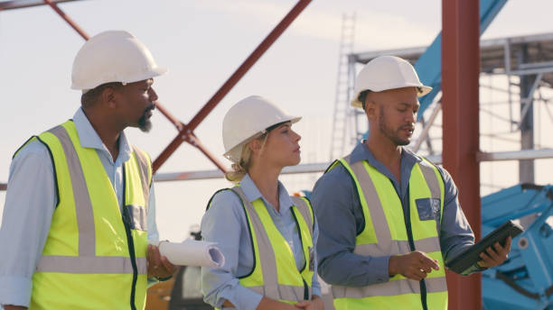 istock Talking, construction worker and tablet outdoor for planning building, architecture and vision. Engineer team or people on app for collaboration and innovation for engineering development 1499135878