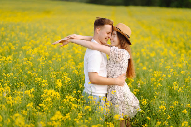 istock Young Couple in the blooming field 1499137555