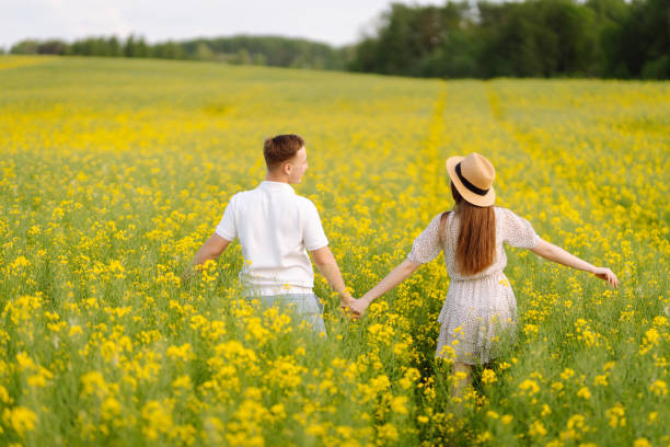 istock Young Couple in the blooming field 1499137561