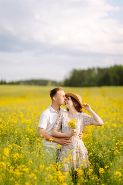 istock Young Couple in the blooming field 1499137577