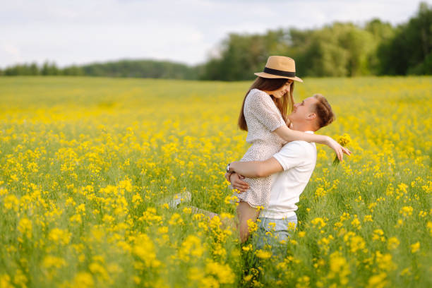 istock Young Couple in the blooming field 1499137605