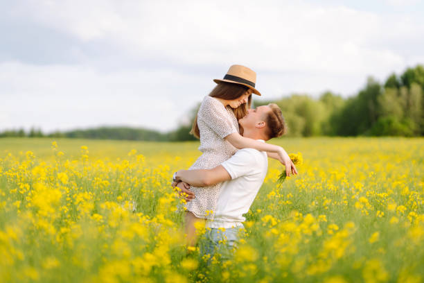 istock Young Couple in the blooming field 1499137609