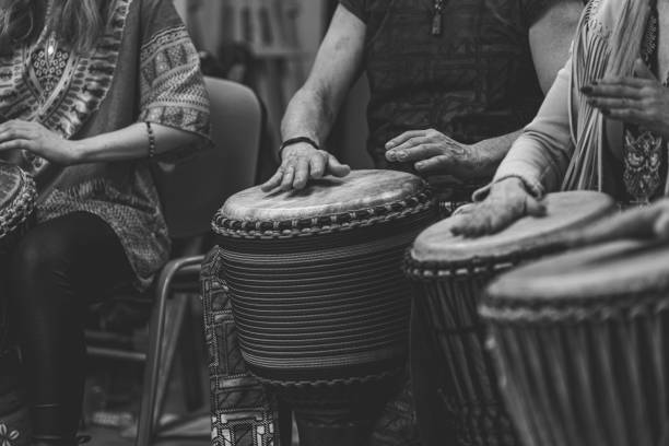 istock a group of people sitting around one another with drum equipment 1499137661