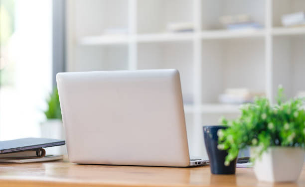 istock Laptop computer, coffee cup and financial document on office desk. 1499139787