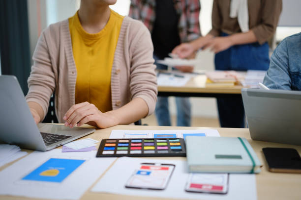 istock Cropped shot of female website developer planning application development for web mobile phone at co working space. 1499139983