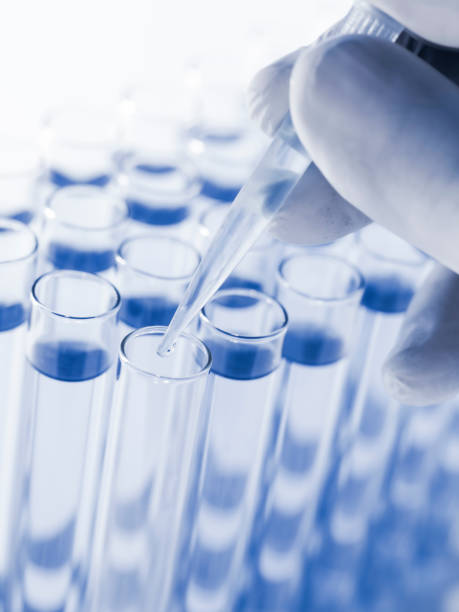 istock Droplet Falling from Pipette into Test Tube. 1499140064
