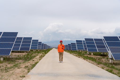 Positive portrait of Asian male engineer inside solar power plant