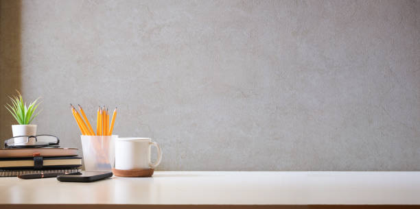 istock Comfortable workplace with coffee, stationery and houseplant on white table. Home office, copy space. 1499142825