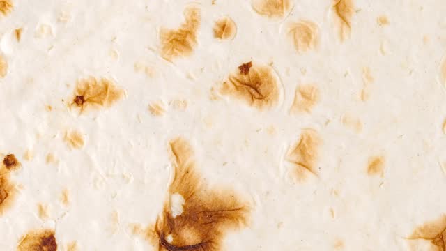Pita tortilla close-up, rotating, turning, macro, top view