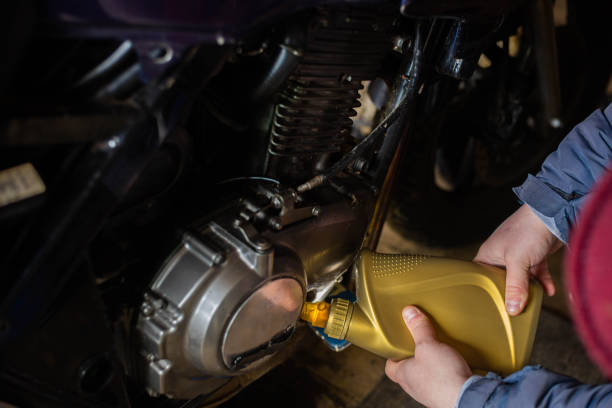 istock man pouring new engine oil into a motorcycle 1499146696