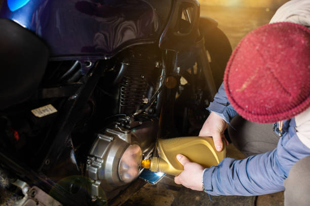 istock man pouring new engine oil into a motorcycle 1499146699