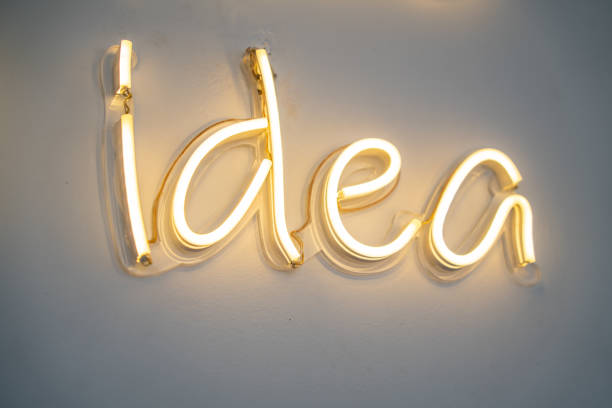 istock idea, LED neon light on wall ,Business background design with long shadow text 1499150854