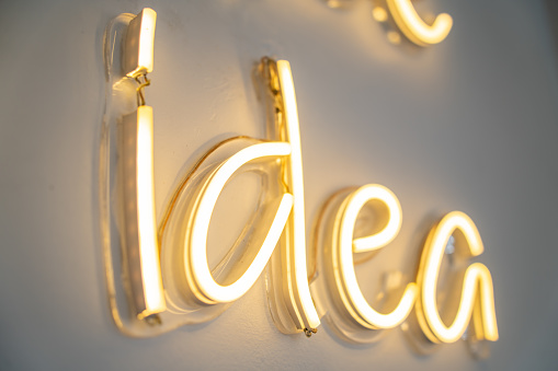 idea, LED neon light on wall ,Business background design with long shadow text, can be used for presentation, workflow layout, conference, advertising, infographic. Clean and modern style design