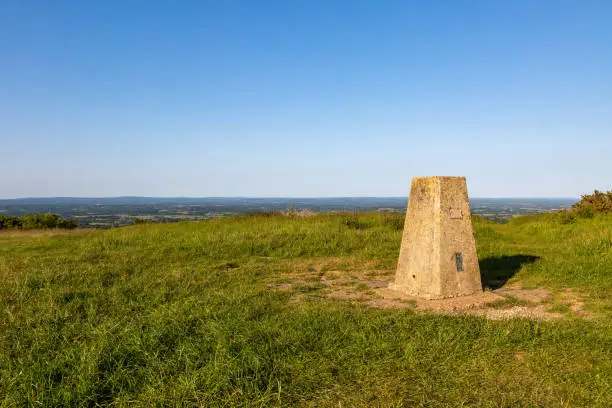A trig point on Ditchling Beacon in the South Downs, on a sunny early summer's day