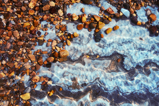 The Dead Sea, also known by other names, is a salt lake bordered by Jordan to the east and the West Bank and Israel to the west.