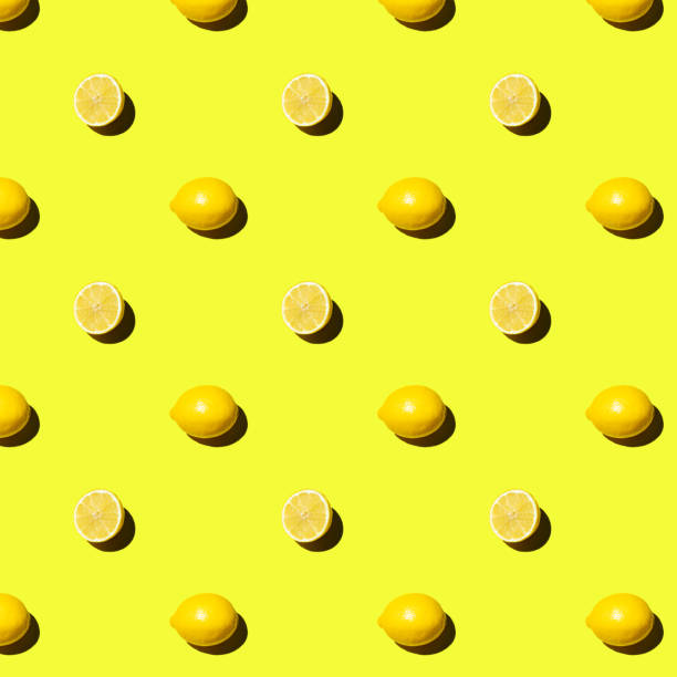 istock Seamless pattern fresh whole and cut lemon on yellow background 1499156893