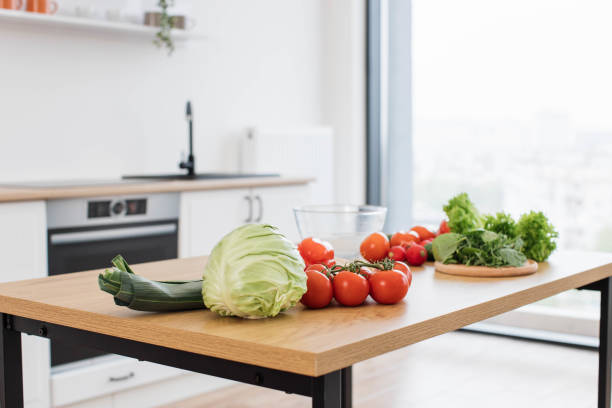 istock Fresh raw ingredients for salad placed on table in kitchen 1499160297