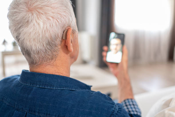 istock Senior Man With Hearing Aid Having Video Conference 1499161461