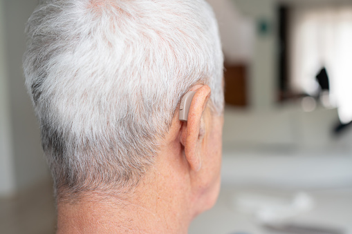 A Senior Man With Hearing Aid